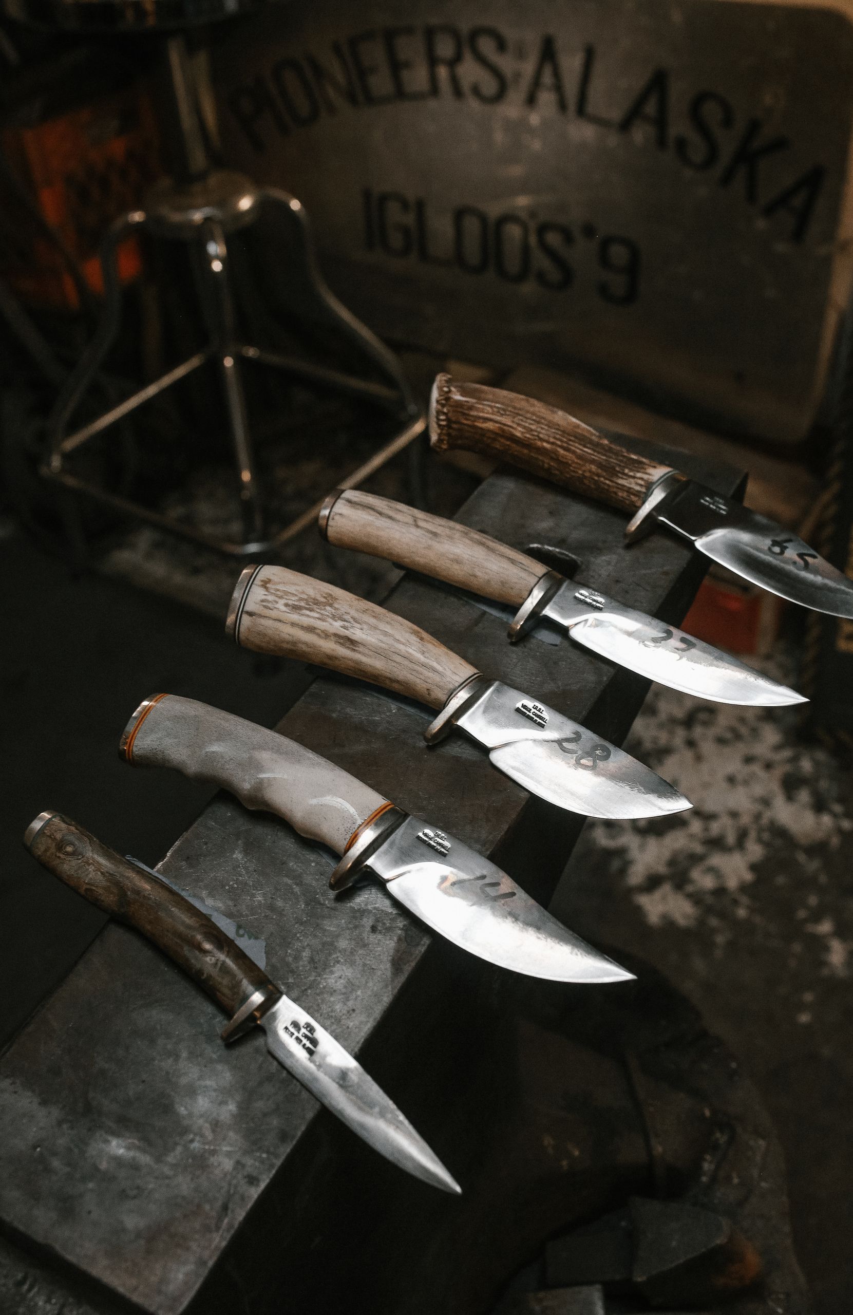 Showcase of traditional knives at an Alaskan museum, highlighting pioneer craftsmanship.